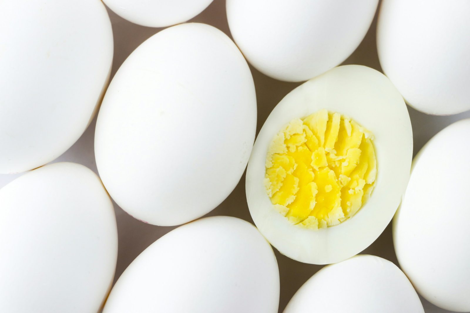 How to boil an egg, white egg lot on brown wooden table