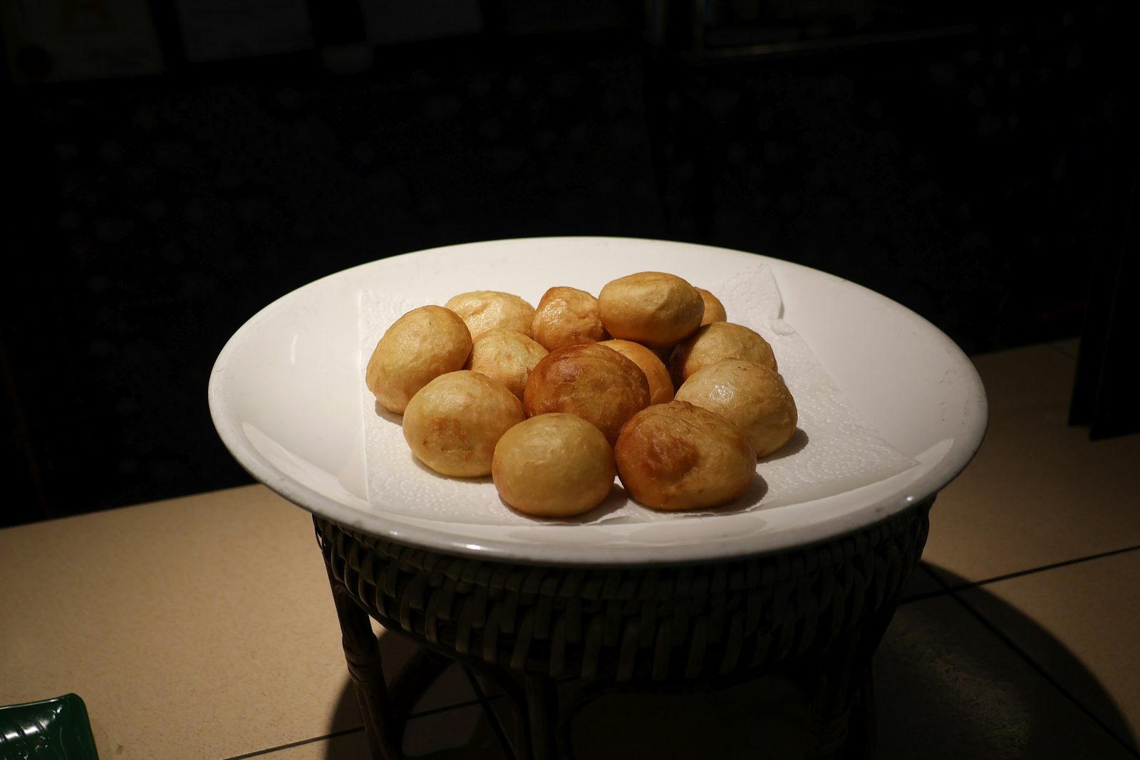 Trinidadian Pholourie, A white plate filled with golden brown fried dough balls